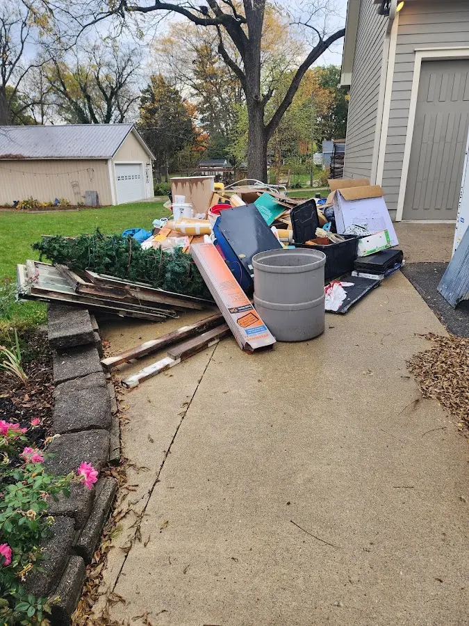 Dumpster being loaded with debris for Roofing Dumpster Rental in Cary